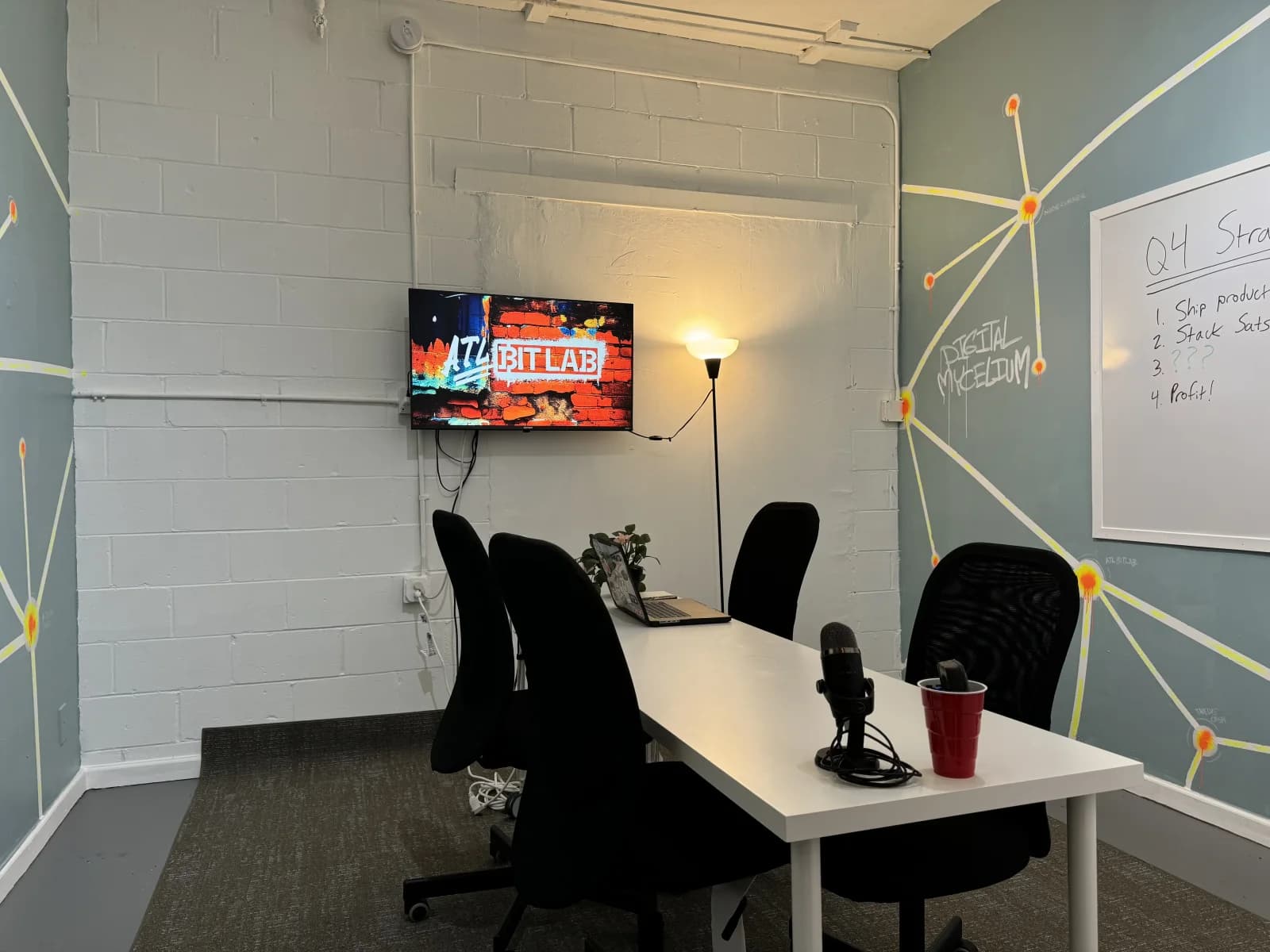 Digital Mycelium conference room with a meeting table, screen, and whiteboard